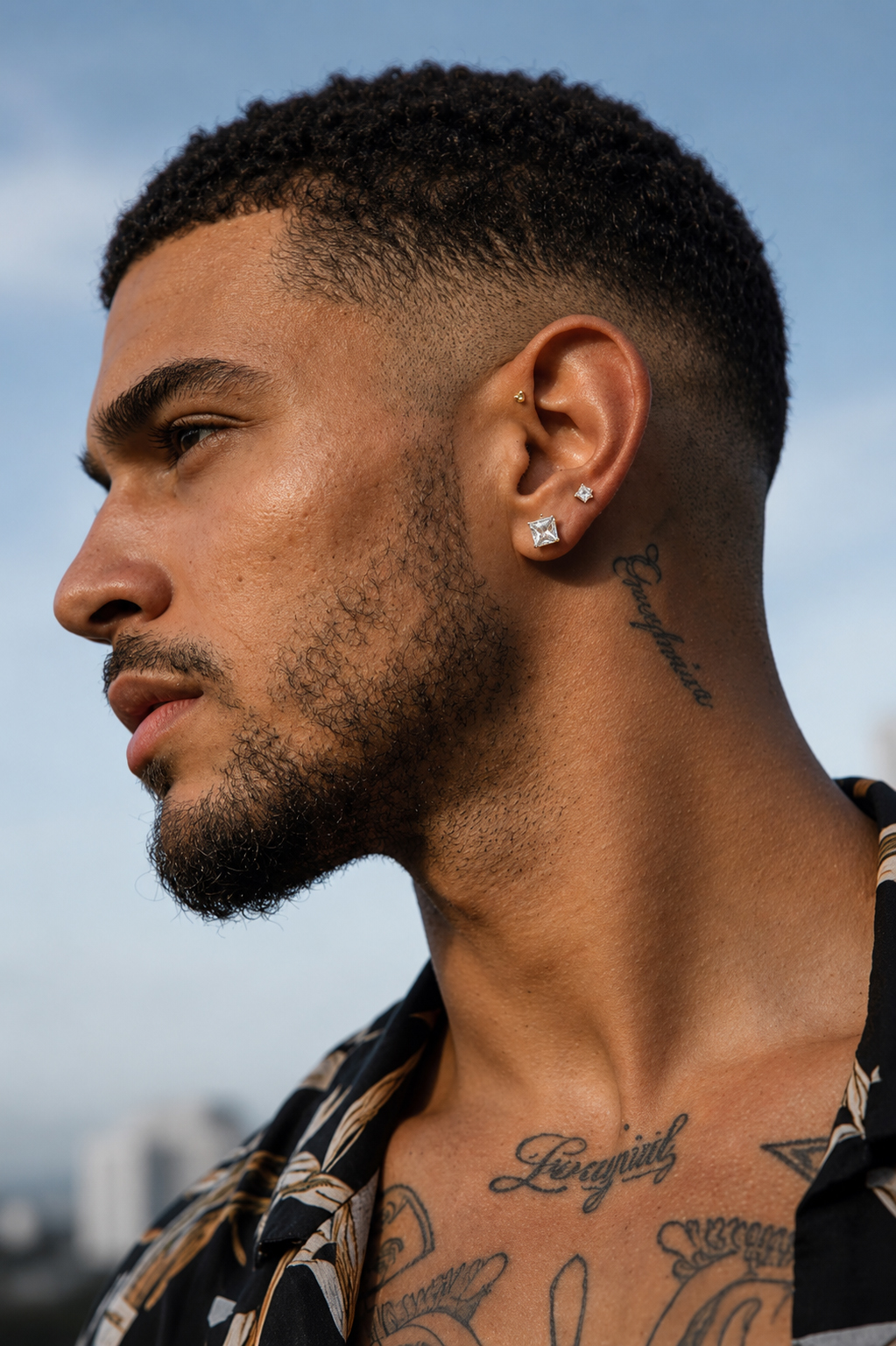 Man wearing brilliant square-cut silver-tone stud earrings for a bold modern men’s jewelry look.