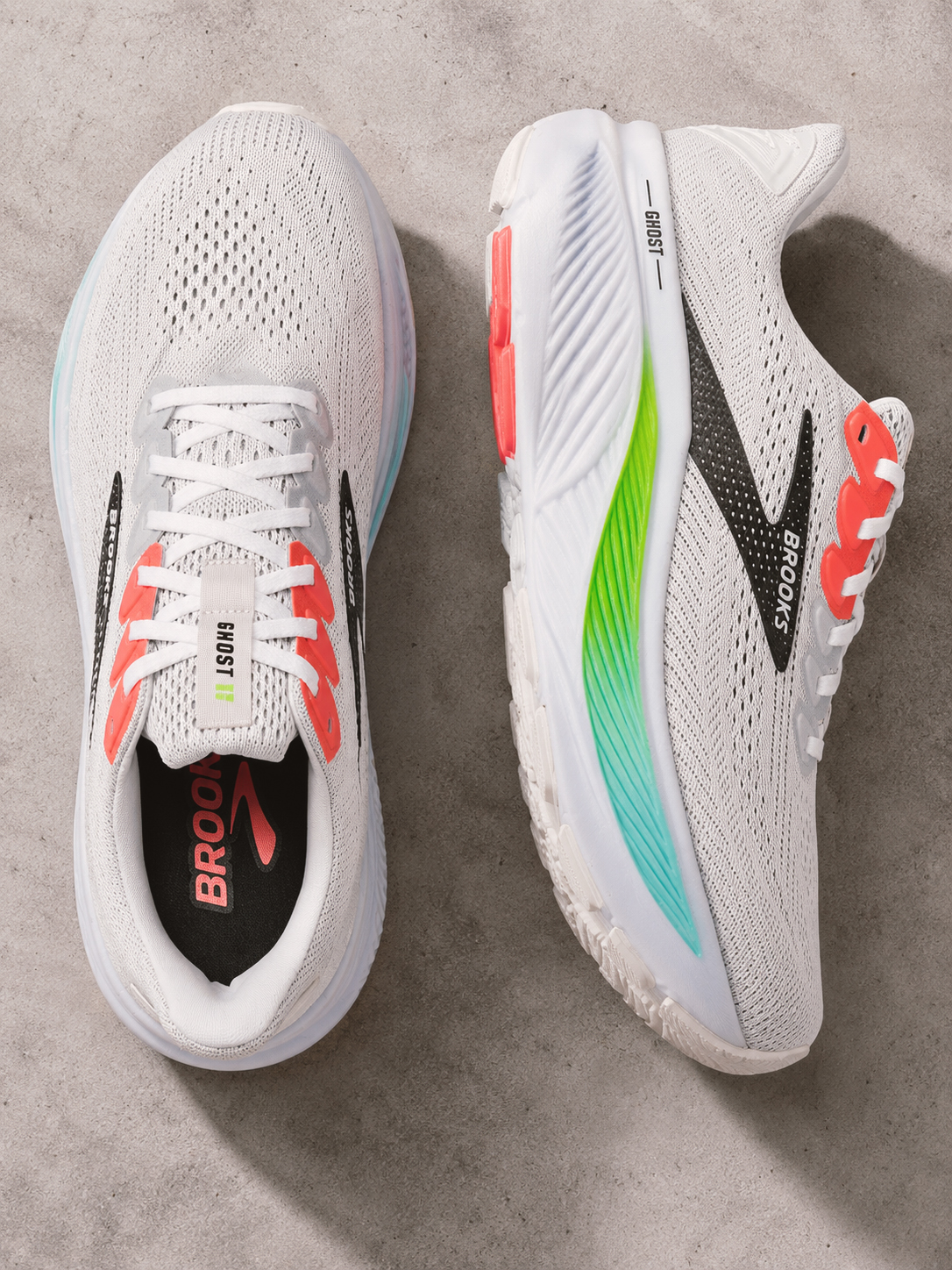 Brooks Ghost 17 men’s running shoes in white with black, coral, green and blue details.