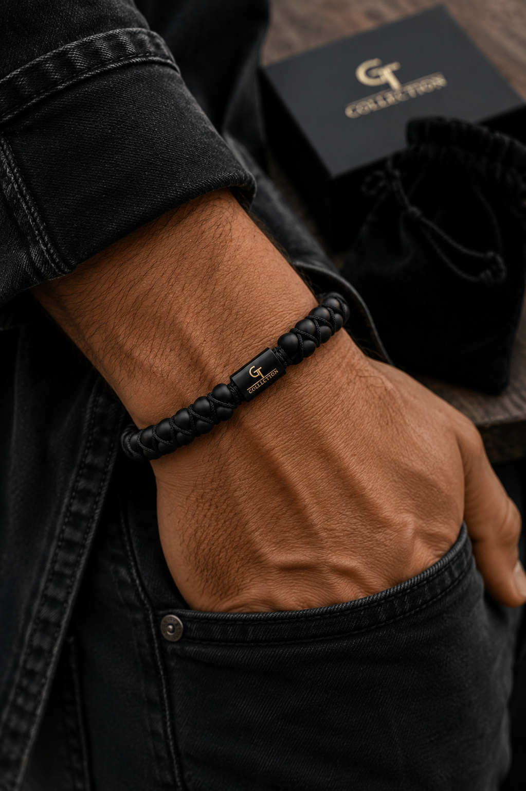Man wearing a GT Collection black onyx beaded bracelet with a blazer, white shirt and blue jeans.