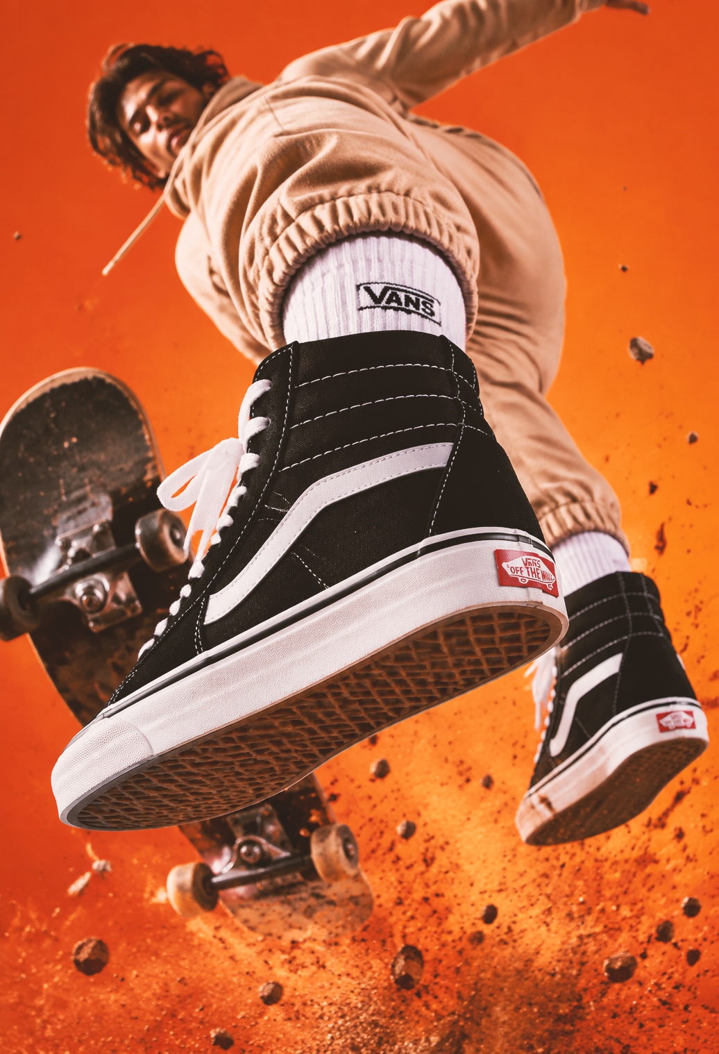 man doing skateboard trick wearing ban sneakers